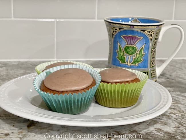 Scottish Coburg Cakes on a plate next to a cup of tea in a Scottish mug Scottish Coburg Cakes on a plate next to a cup of tea in a Scottish mug