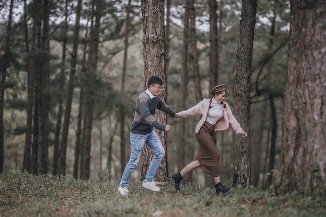 Couple running through woods Couple running through woods
